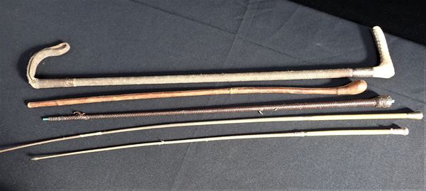 TWO GILT METAL TOPPED RIDING CROPS AND THREE OTHERS