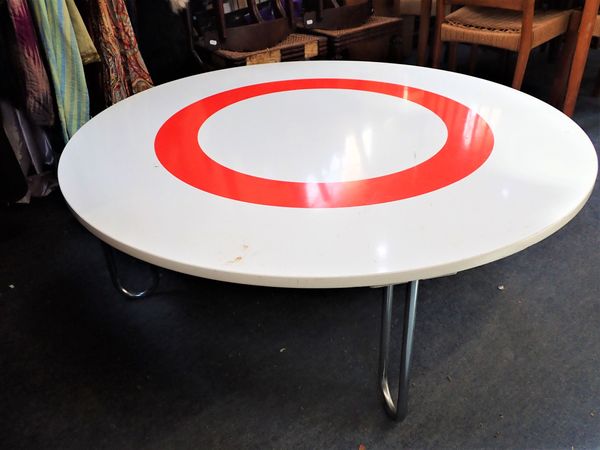 A MODERN WHITE CIRCULAR COFFEE TABLE WITH RED CIRCLE DESIGN