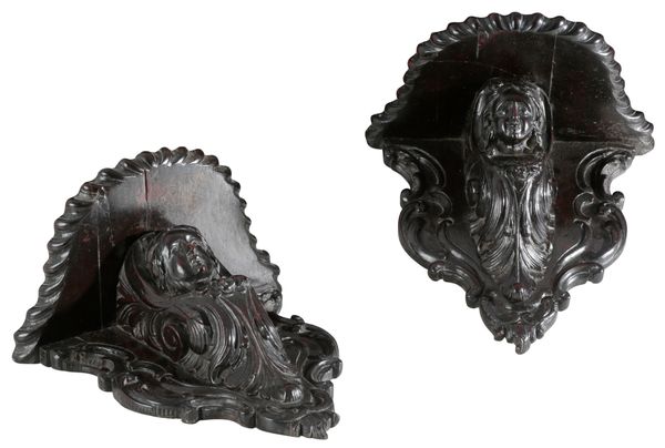 A PAIR OF CONTINENTAL, PROBABLY ITALIAN, CARVED WALNUT WALL BRACKETS