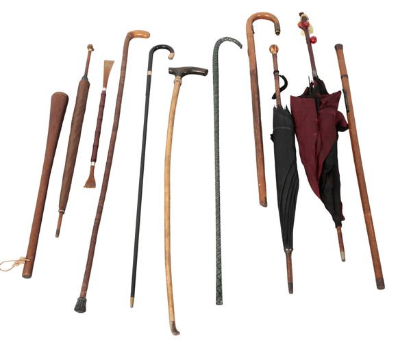 A COLLECTION OF WALKING STICKS AND PARASOLS