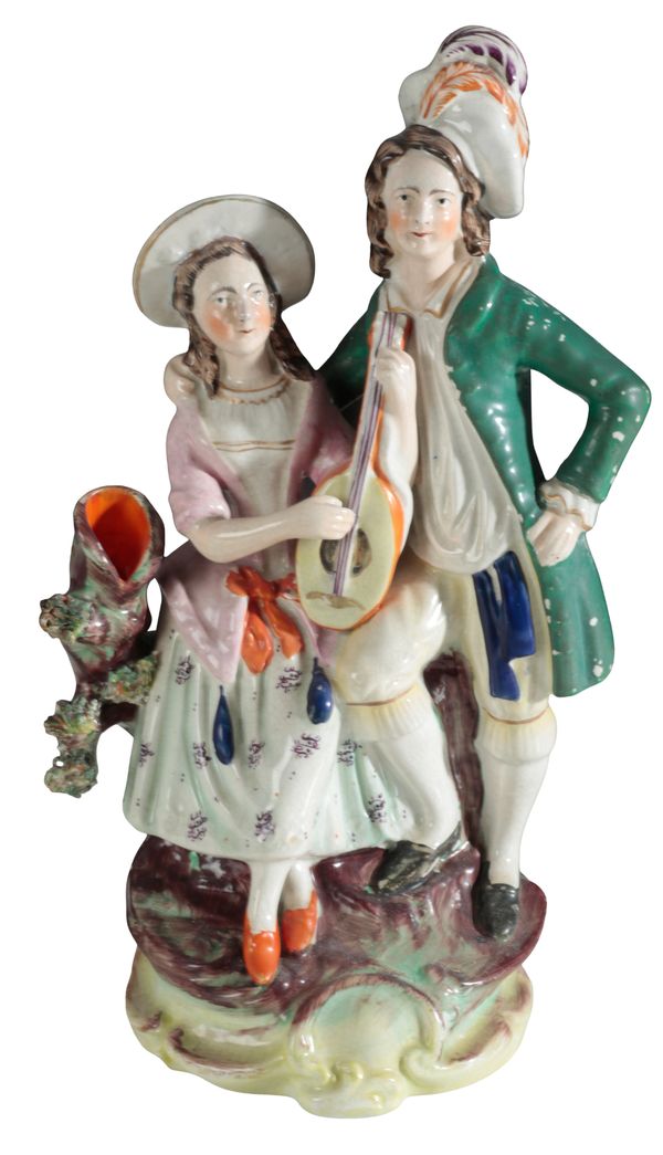 A VICTORIAN STAFFORDSHIRE POTTERY SPILL VASE, MUSICIANS