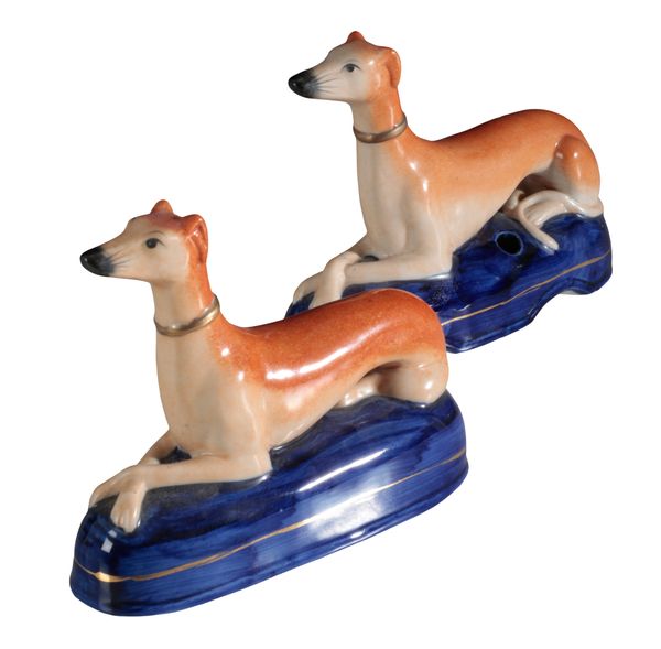 A PAIR OF LATE VICTORIAN STAFFORDSHIRE SLIP CAST PORCELAIN GREYHOUND INKWELLS