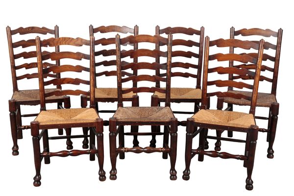 A MATCHED SET OF SEVEN LADDER BACK DINING CHAIRS