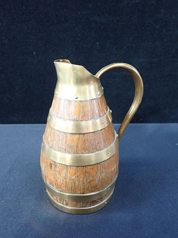 A GERAUD LAFITTE BRASS-BOUND OAK JUG