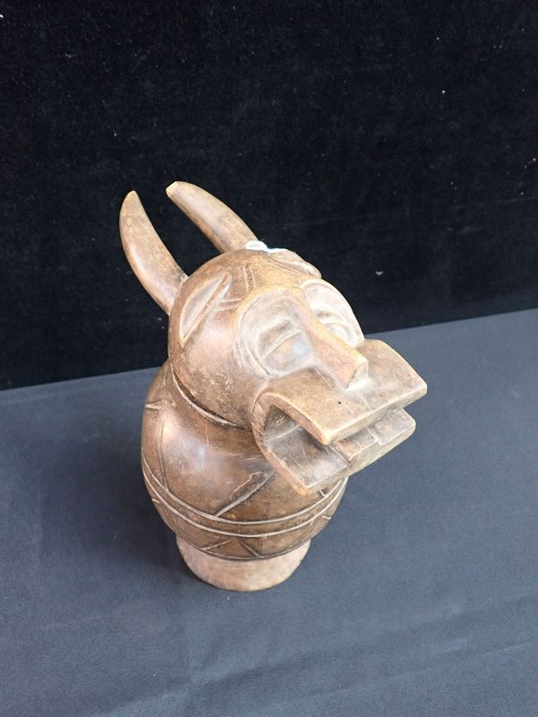 AN AFRICAN CARVED LIDDED VESSEL