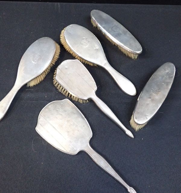 FIVE SILVER-BACKED BRUSHES AND A MIRROR