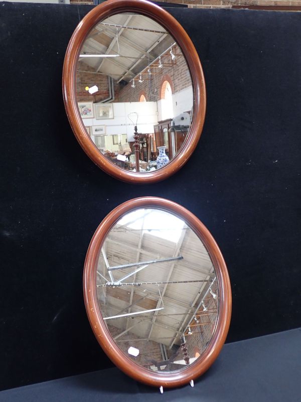 A PAIR OF EDWARDIAN MAHOGANY FRAMED OVAL MIRRORS