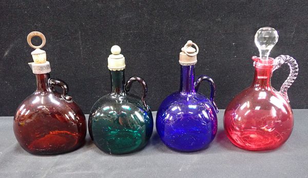 FOUR VICTORIAN COLOURED GLASS DECANTERS