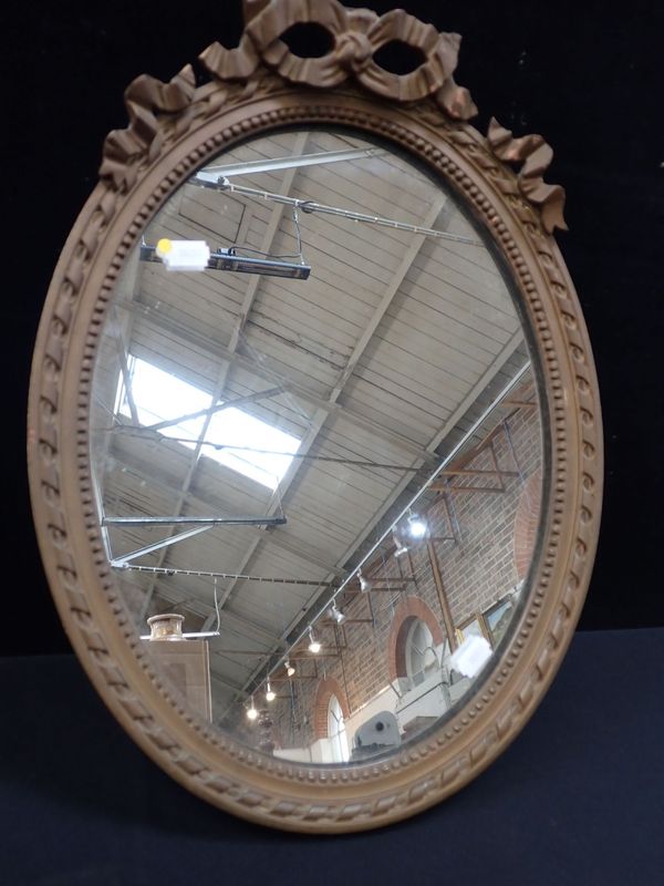 A  GEORGE III STYLE GILT FRAMED OVAL WALL MIRROR