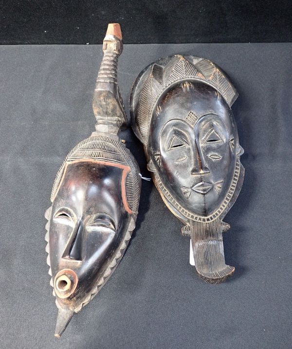 TWO AFRICAN MASKS, ONE SURMOUNTED BY A CHICKEN