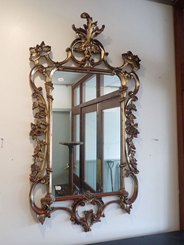 A GILT FRAMED MIRROR, OF ROCOCO DESIGN