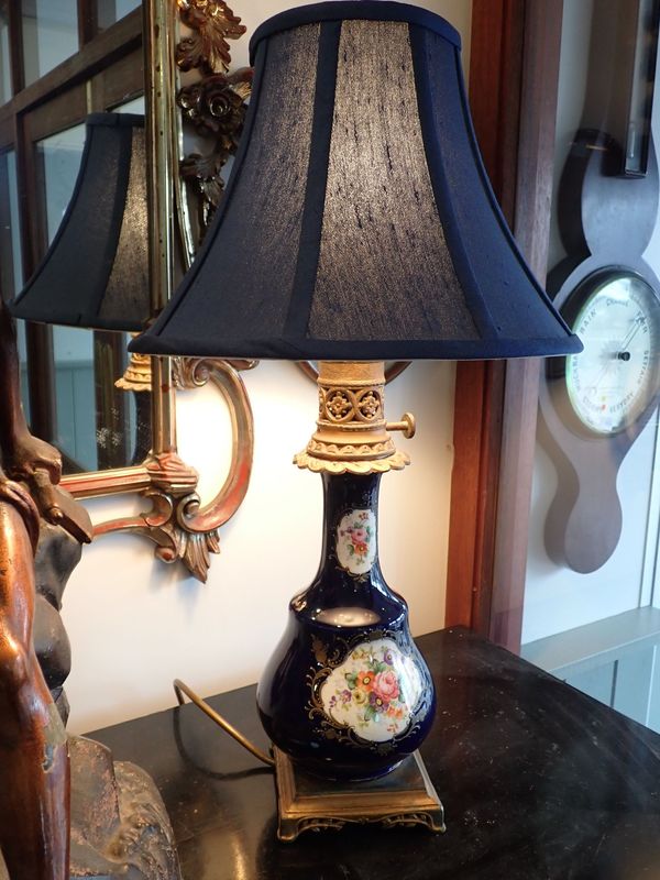 A FRENCH CERAMIC AND SPELTER TABLE LAMP