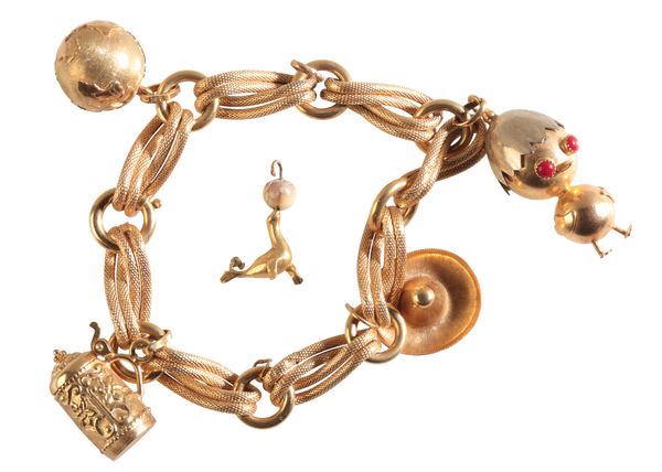 A YELLOW METAL CHARM BRACELET