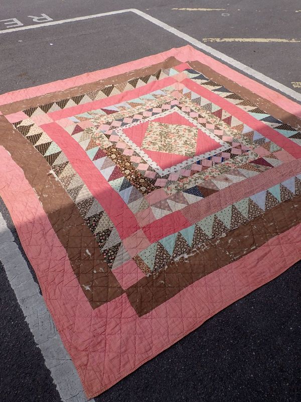 A PATCHWORK QUILT, WORKED WITH VARIOUS PRINTED COTTONS