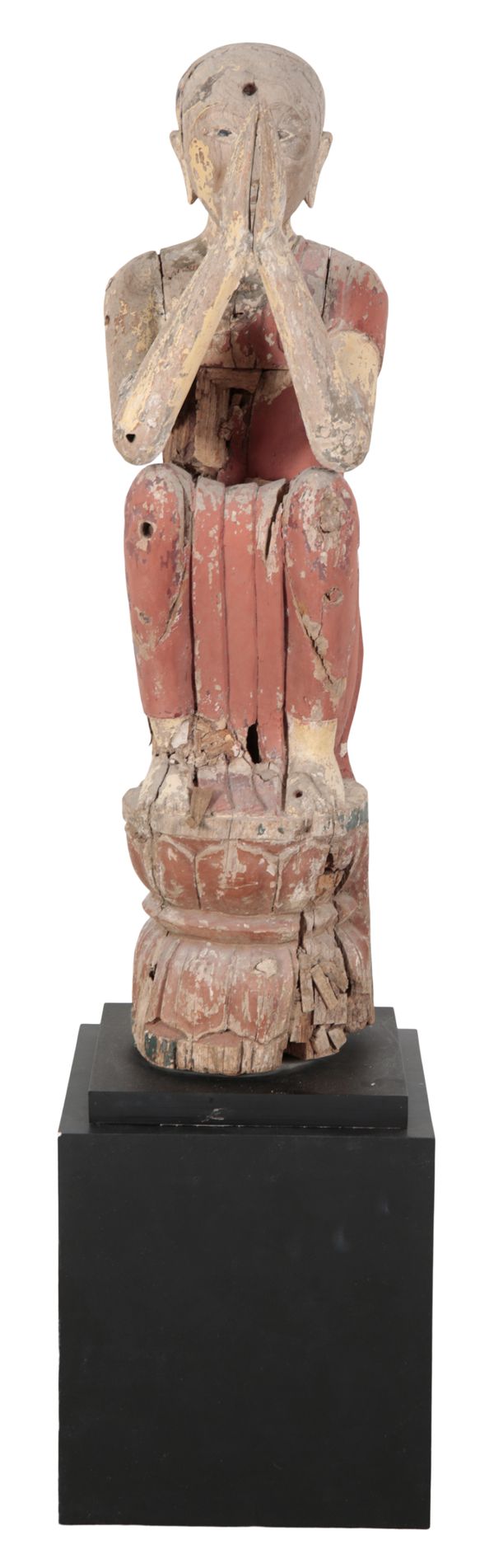 A CARVED AND PAINTED WOOD FIGURE OF A PRAYING MONK