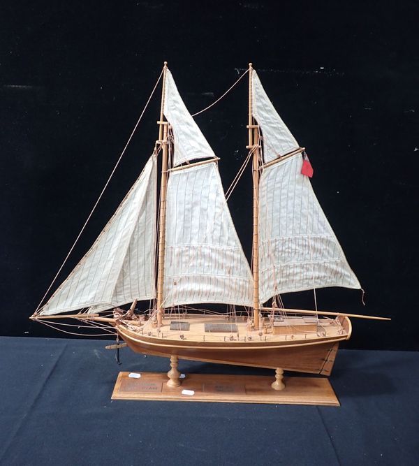 A WOODEN MODEL SAILING BOAT, FLYING THE RED ENSIGN