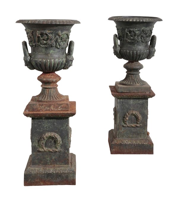 A PAIR OF CAST IRON URNS