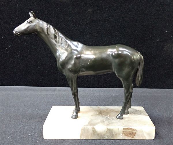 A BRONZE HORSE ON A MARBLE BASE