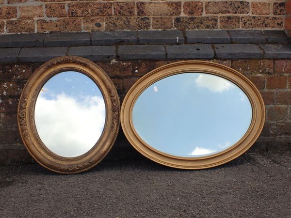 TWO GILT FRAMED OVAL WALL MIRRORS