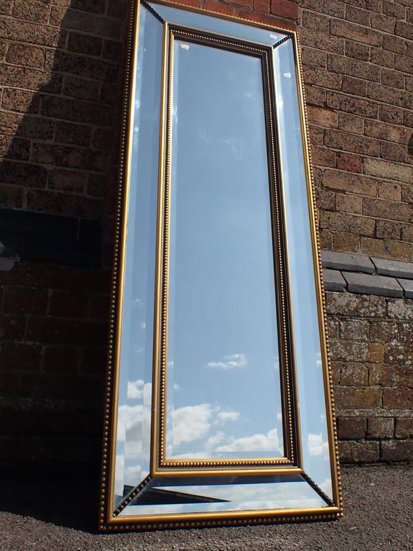 A REGENCY STYLE GILT-FRAMED WALL MIRROR