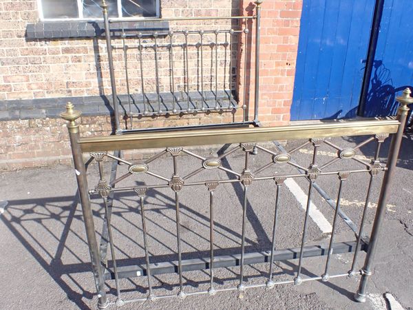 AN EDWARDIAN IRON AND BRASS BED