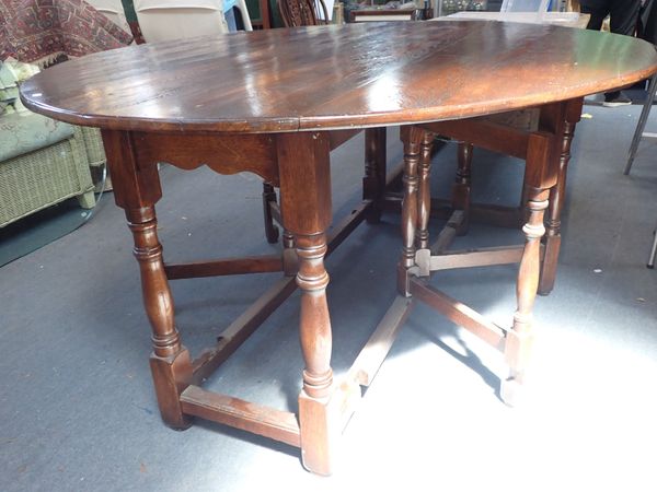 A SUBSTANTIAL OVAL OAK DOUBLE-GATELEG TABLE