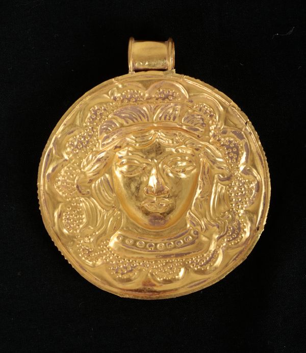 A GOLD PENDANT OF A WARRIOR QUEEN