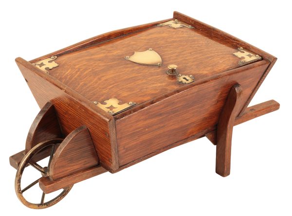 A RARE HUMIDOR IN THE FORM OF AN OAK AND BRASS WHEELBARROW