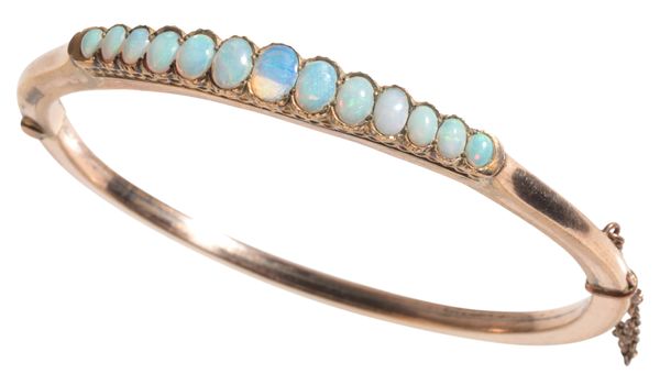 A GOLD COLOURED METAL OPAL HINGED BANGLE