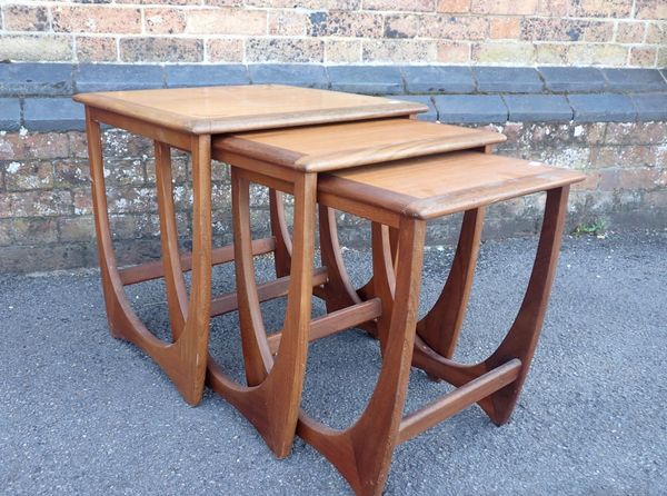 A NEST OF THREE MID-CENTURY MODERN TEAK OCCASIONAL TABLES