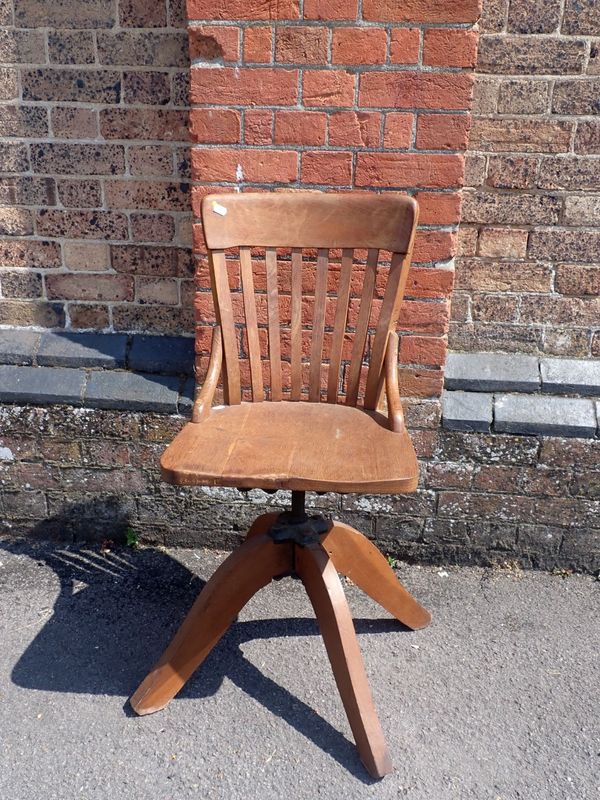 A 1920s OAK SWIVEL DESK CHAIR