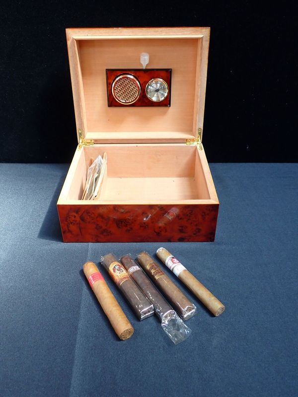 A WALNUT HUMIDOR, CONTAINING A FEW CIGARS