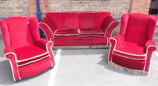 A 1920S SOFA, WITH LOW BACK AND SPLAYED ARMS, ON BUN FEET