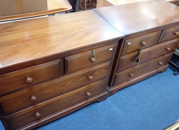 A PAIR OF ERCOL STAINED PINE CHESTS OF DRAWERS