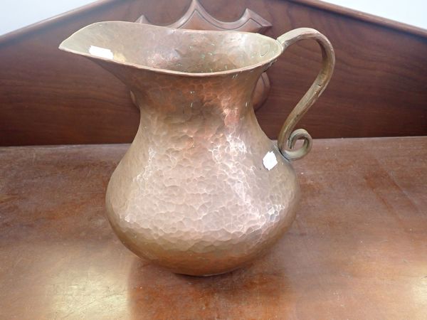 A HAMMERED ARTS AND CRAFTS STYLE COPPER JUG