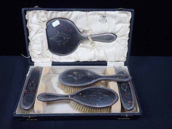 A SILVER MOUNTED TORTOISESHELL DRESSING TABLE SET