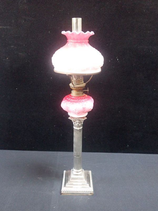 A VICTORIAN OIL LAMP, ON A SILVER CORINTHIAN COLUMN BASE