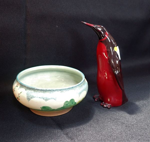 A ROYAL DOULTON FLAMBE PENGUIN, AND A CLARICE CLIFF  'HOLLYHOCKS' BOWL