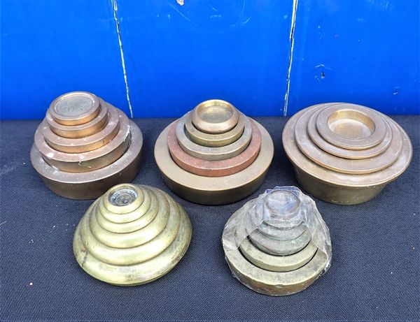 FIVE SETS, OR NEAR SETS, OF STACKING BRASS WEIGHTS