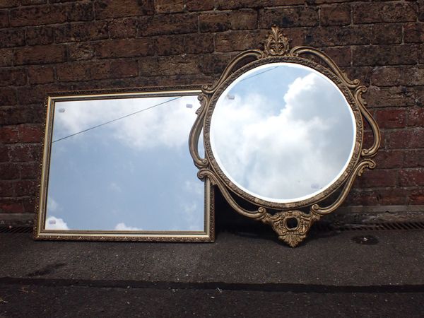 A GILT-FRAMED MIRROR, WITH SCROLLING  MOULDED FRAME