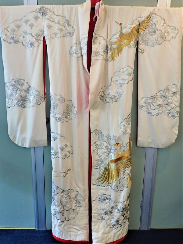 A TRADITIONAL JAPANESE KIMONO, WORKED WITH CRANES AMONGST CLOUDS AND FLOWERS