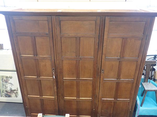 A COUNTRY HOUSE  OAK TRIPLE WARDROBE, MADE FROM SECTIONS OF OLD PANELLING