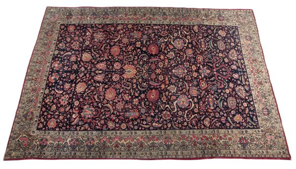 AN ANTIQUE KASHAN CARPET