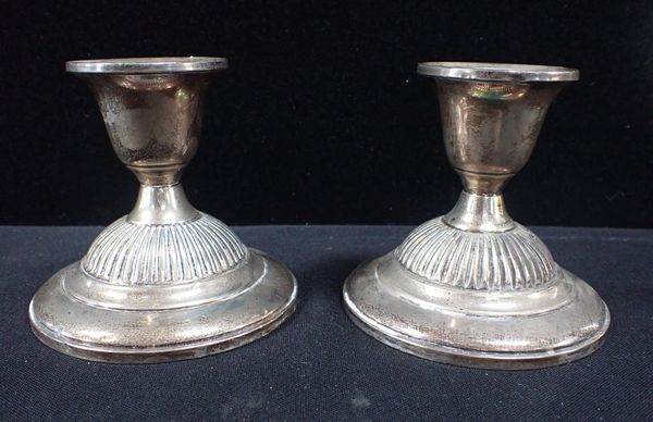 A PAIR OF FISHER STERLING WEIGHTED SILVER CANDLESTICKS