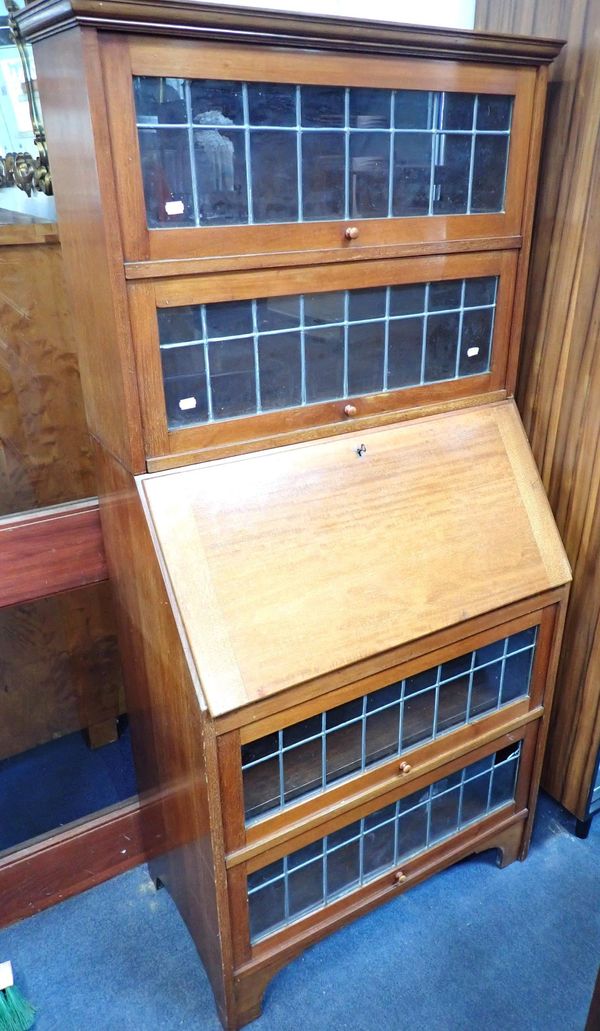 AN EARLY 20th CENTURY BUREAU BOOKCASE  WITH LIFT-UP LEADED GLAZED DOORS