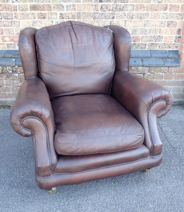 A THOMAS LLOYD BROWN LEATHER CLUB STYLE WING ARMCHAIR