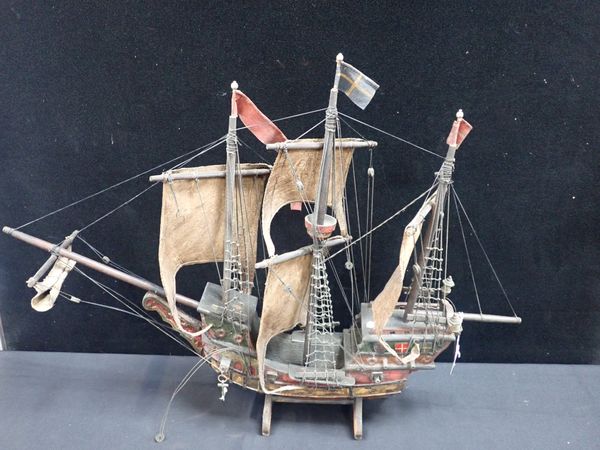 AN EARLY 20TH CENTURY CARVED AND PAINTED MODEL GALLEON