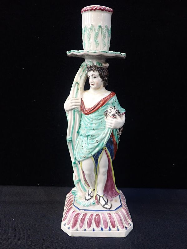 AN 18TH CENTURY PEARLWARE POTTERY FIGURAL CANDLESTICK