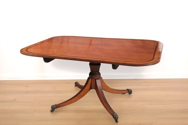 A REGENCY WALNUT BREAKFAST TABLE