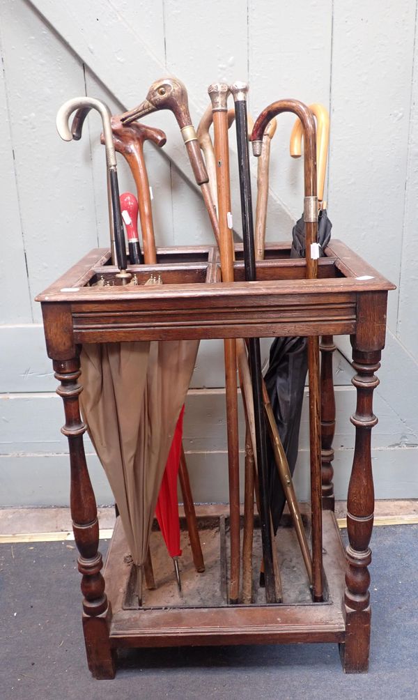 AN EDWARDIAN OAK STICK STAND